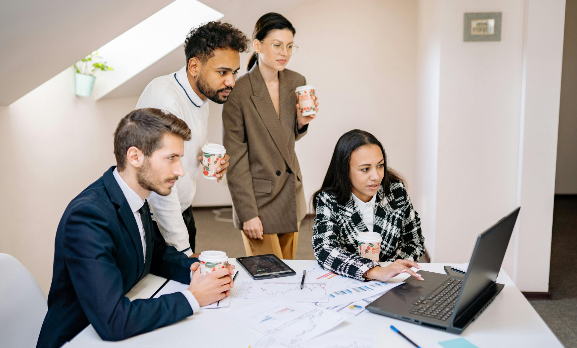 Happy people looking at a laptop, definitely because of TaaS