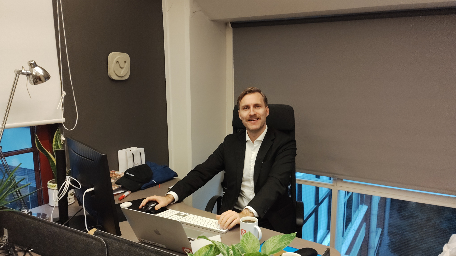 Haakon Rølmann looking dapper at his desk