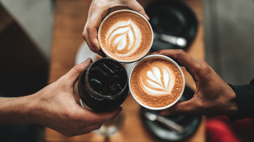 Hands holding coffee cups