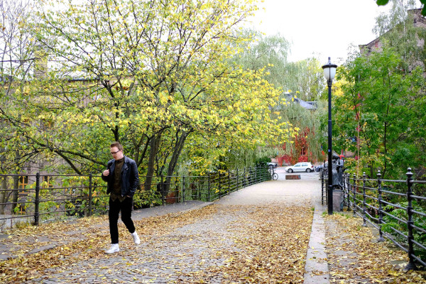 A man walks on Beierbrua bridge in autumn.