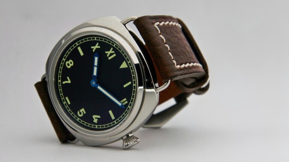 Marina Militare homage to the Panerai 1936 watch with a California dial, lying on a gray background.