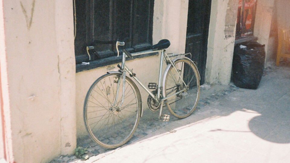 Bike leaning against a building.