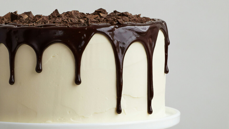 A white chocolate cake with darker chocolate running down from the top