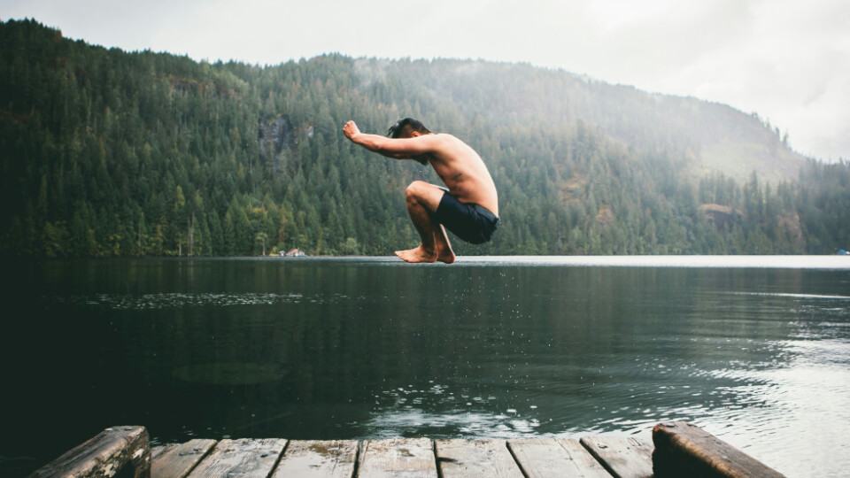 Man jumping off a pier