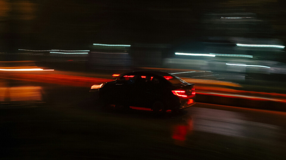 A car moving at night. The lights are stretched showing movement