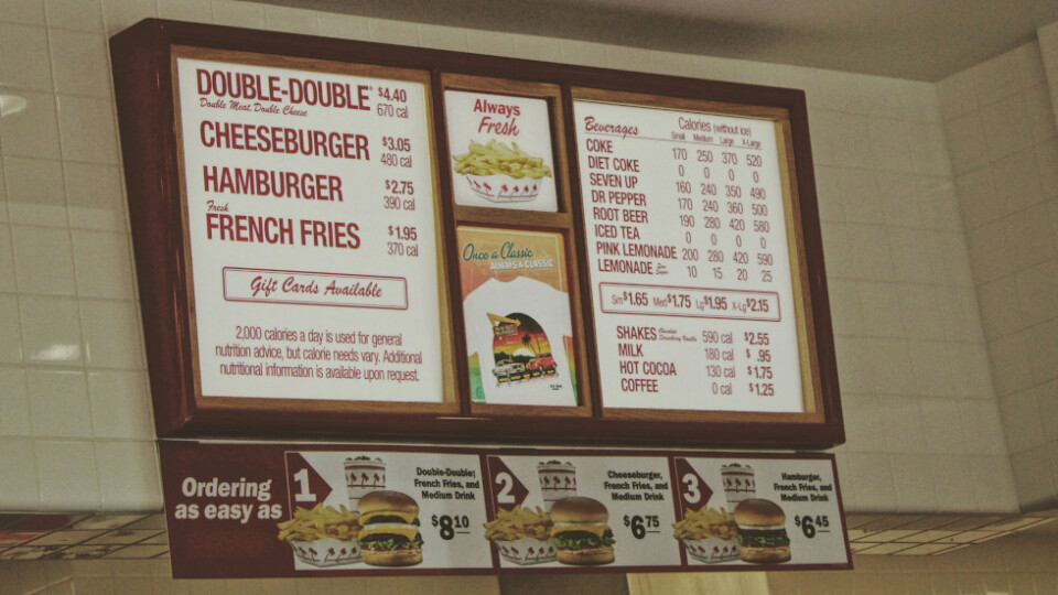 The wall mounted menu from a burger restaurant.