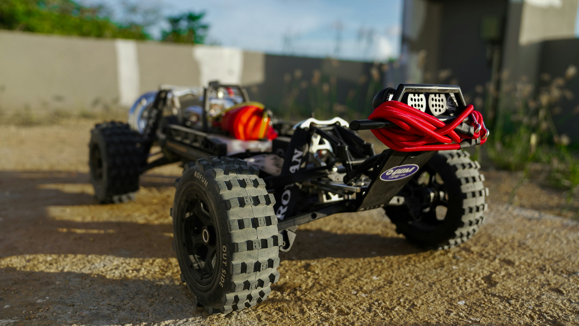 A clos eup of a aadio controlled car, from behind.