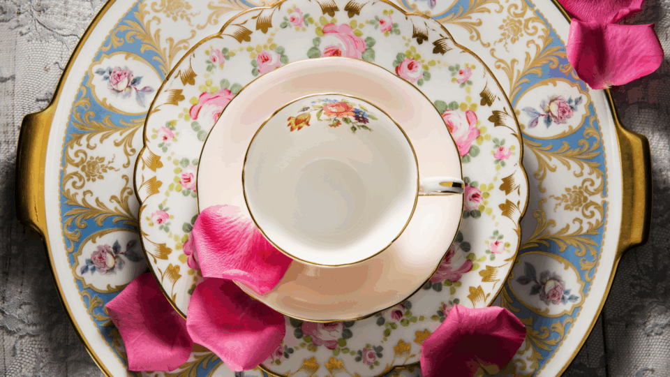 Colorful porcelain set with a teacup, saucer, plate and tray. Viewed from above.