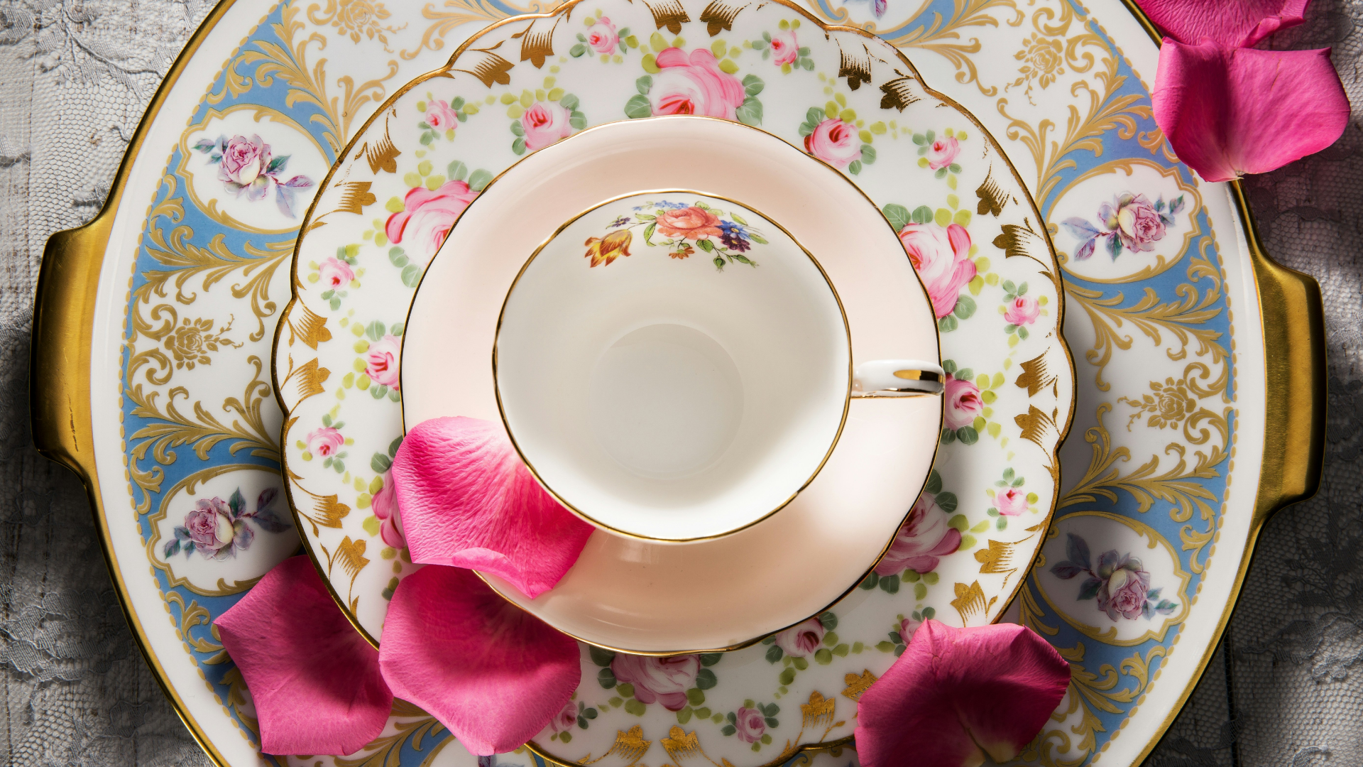 Colorful porcelain set with a teacup, saucer, plate and tray. Viewed from above.