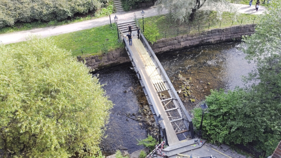Men working on a footbridge below the viewer