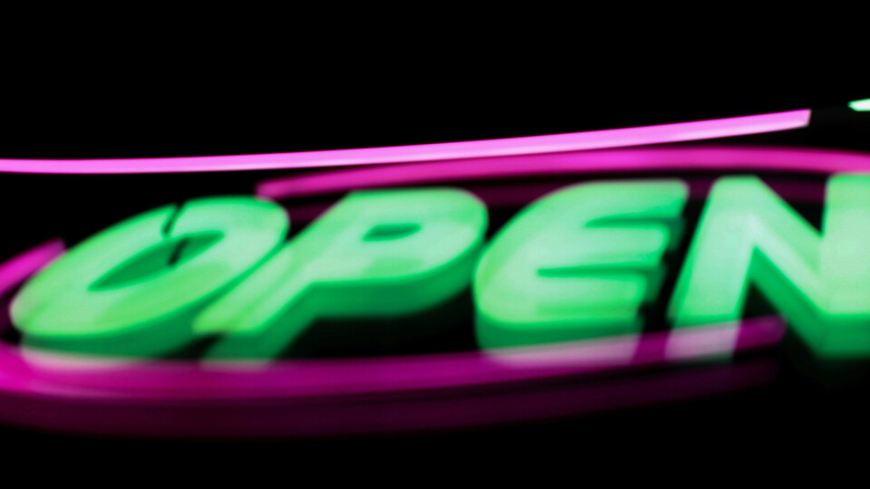 A neon sign that says open
