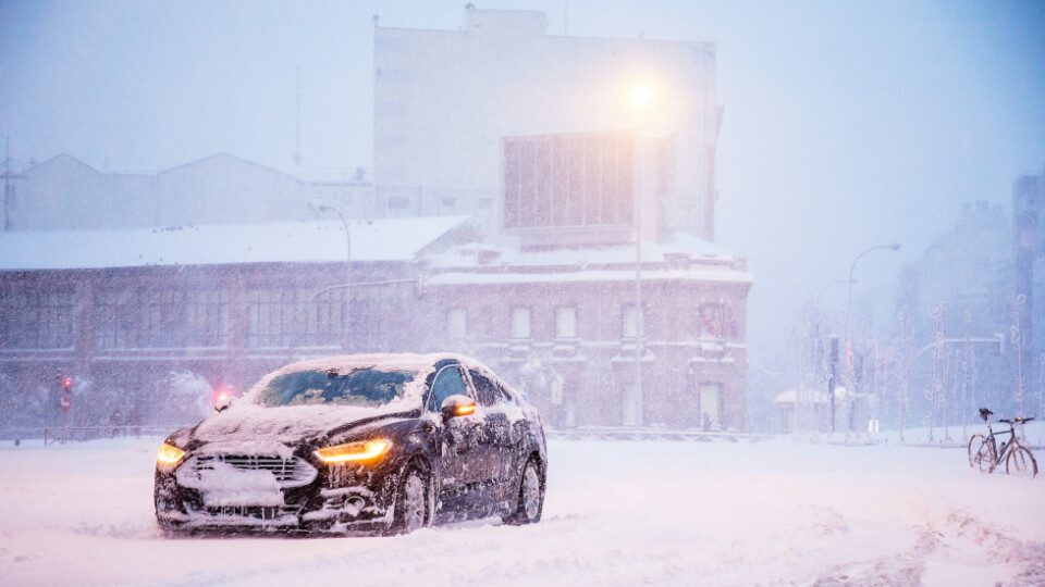 A car in a city covered in snow