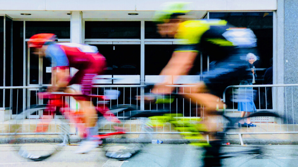 Two cyclists racing. Out of focus due to motion blur.