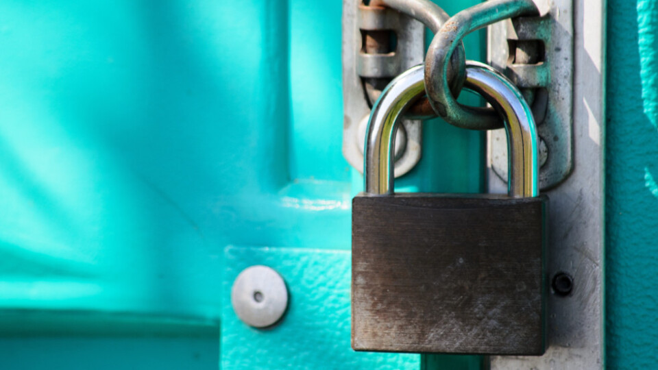 Padlock on a green door