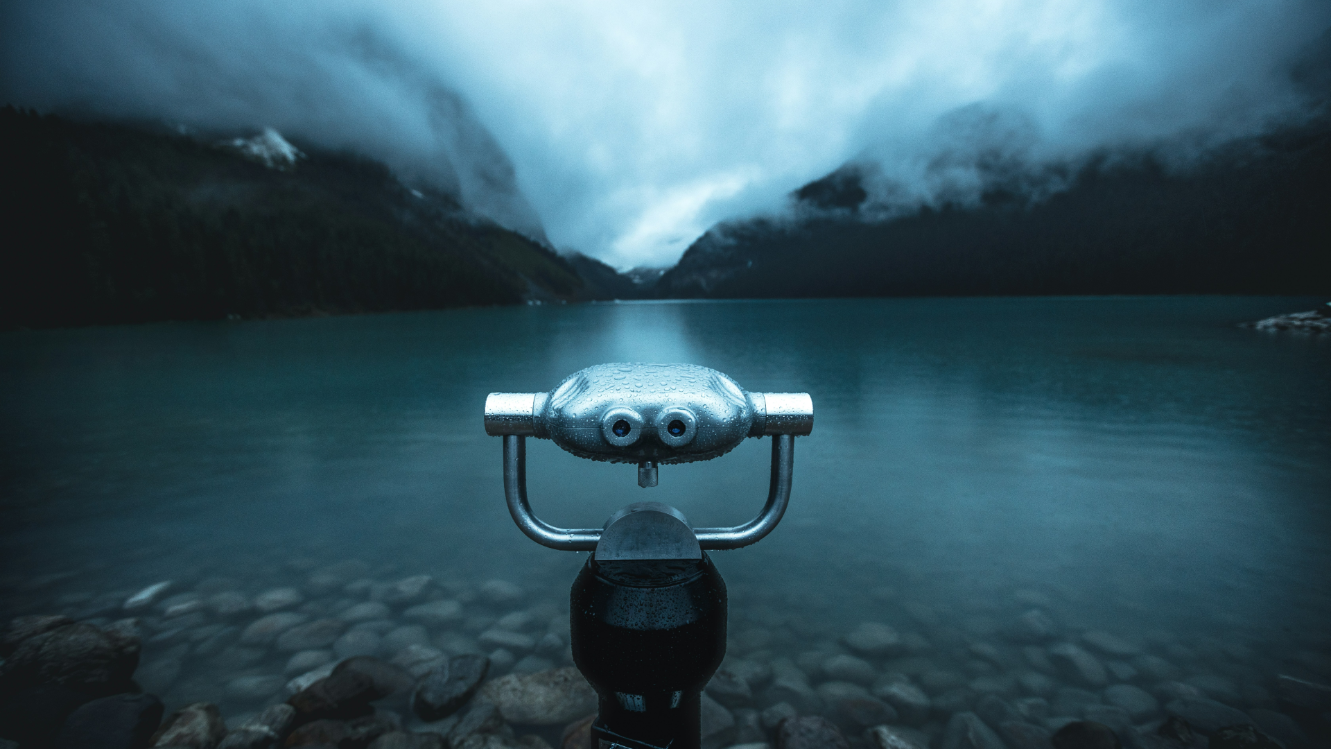 Black binoculars on body of water with