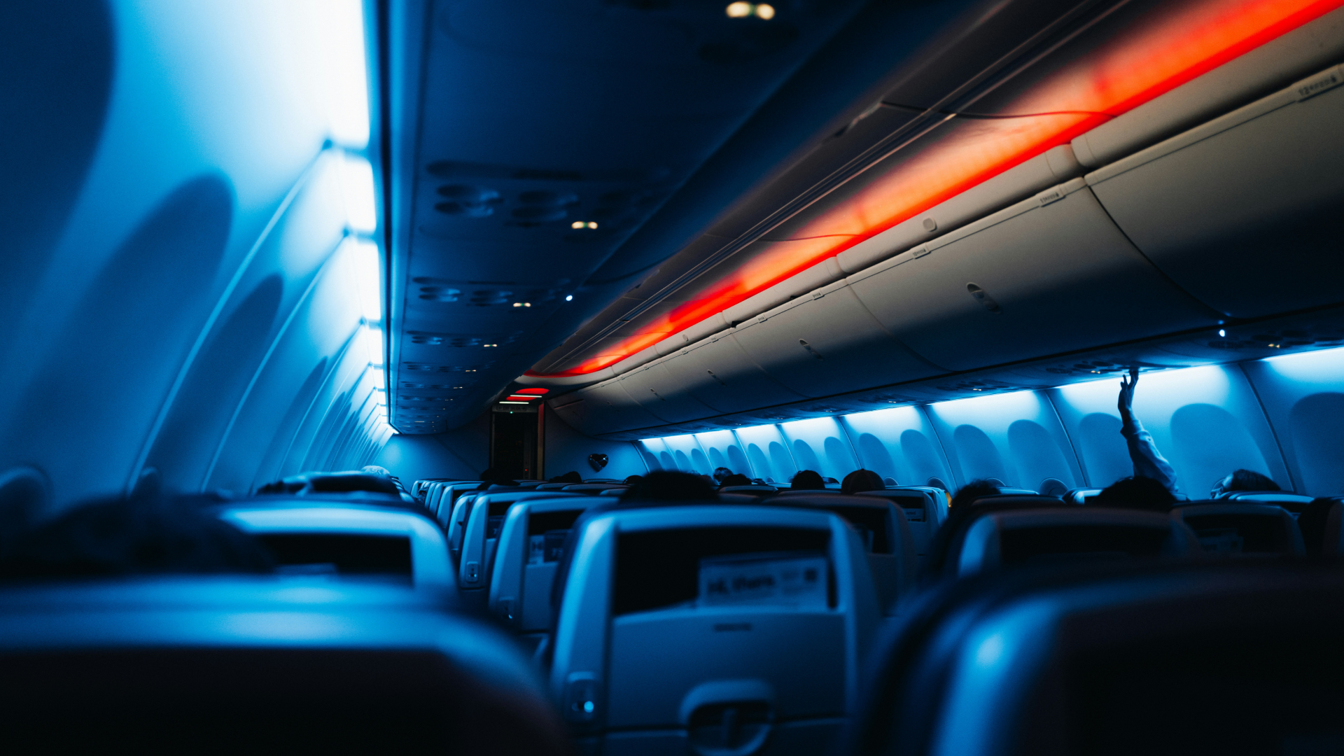 The inside of an airplane with the lights on.