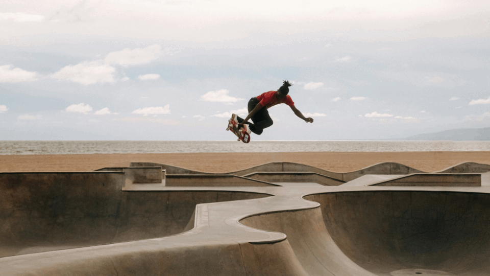 A man flying through the air while riding a skateboard.
