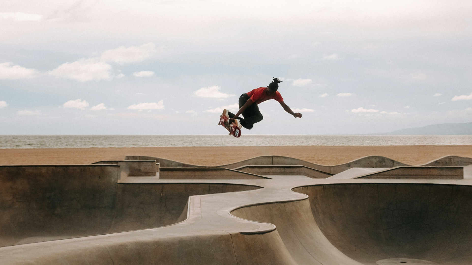 A man flying through the air while riding a skateboard.