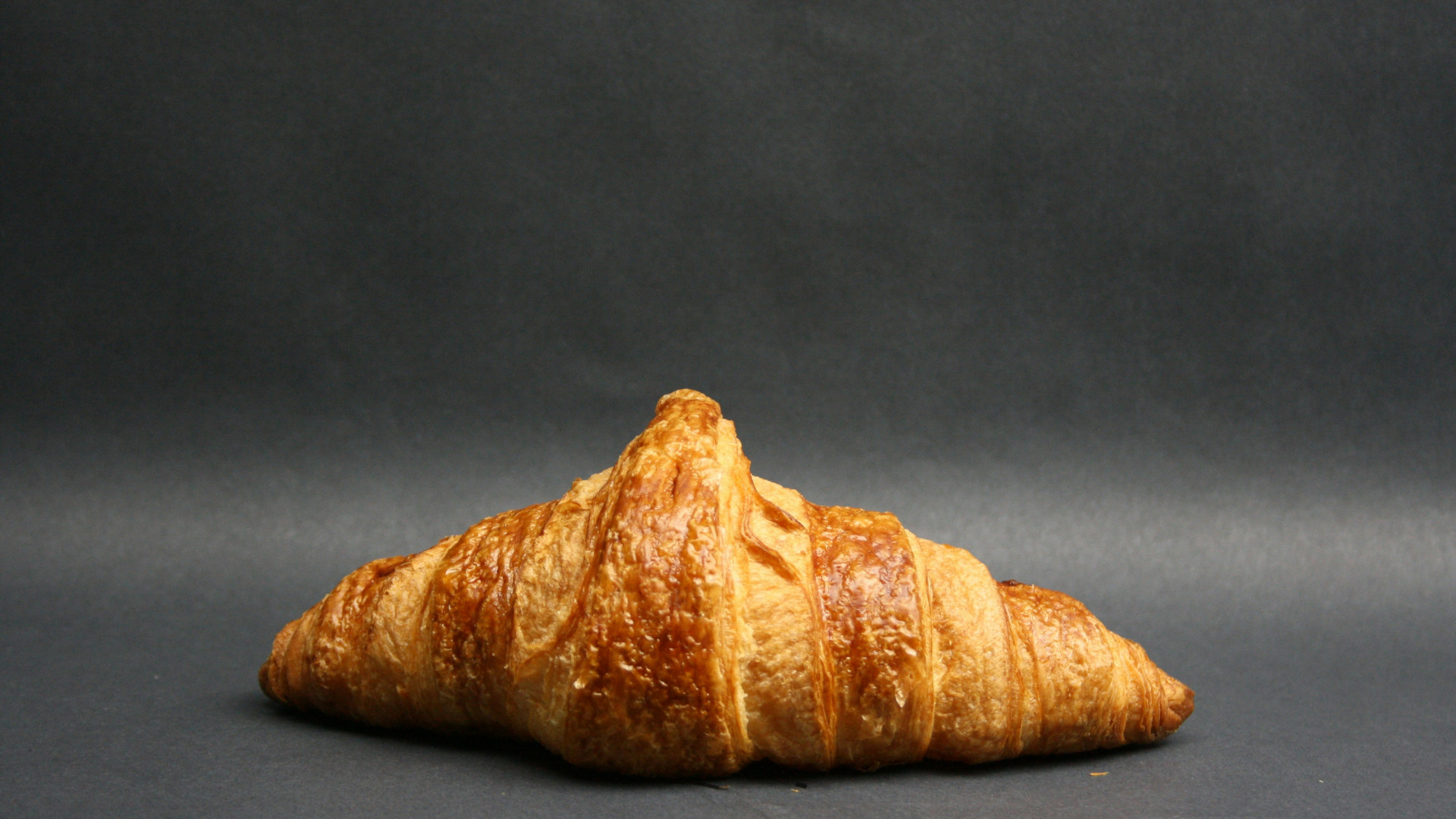 Croissant sitting on a gray surface