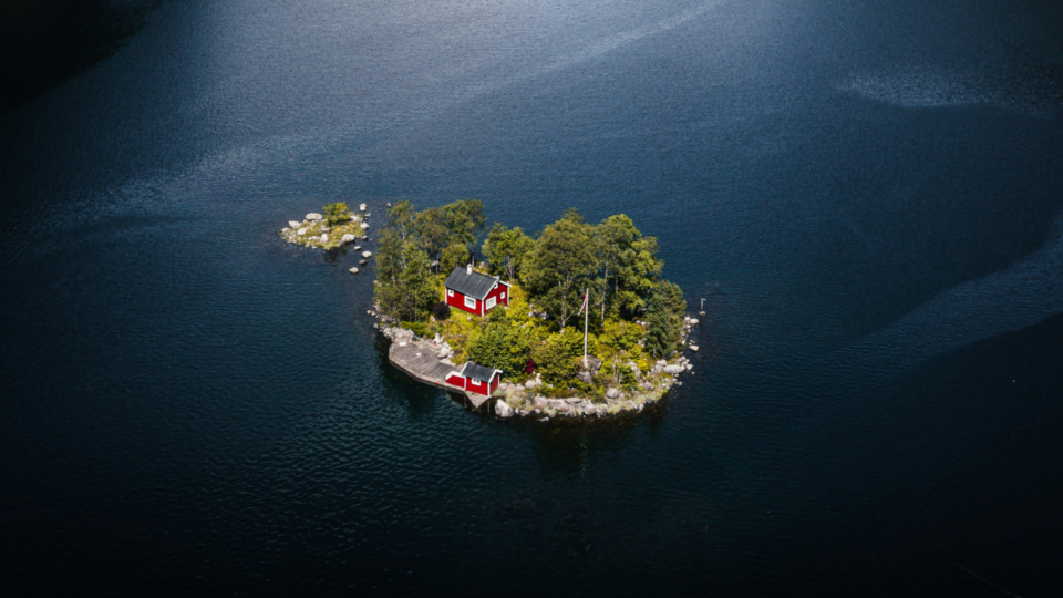 Red little house on an island in the middle of Lovrafjorden.