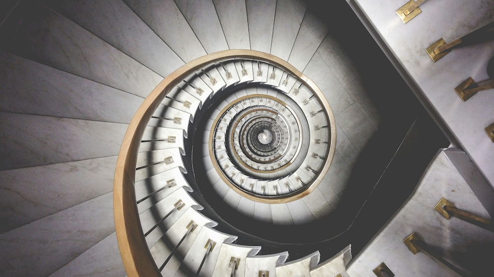 A spiral staircase, looking from above, down through the center