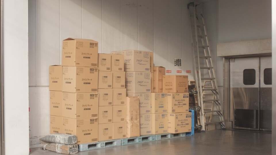 A stack of brown packaging boxes in a warehouse.