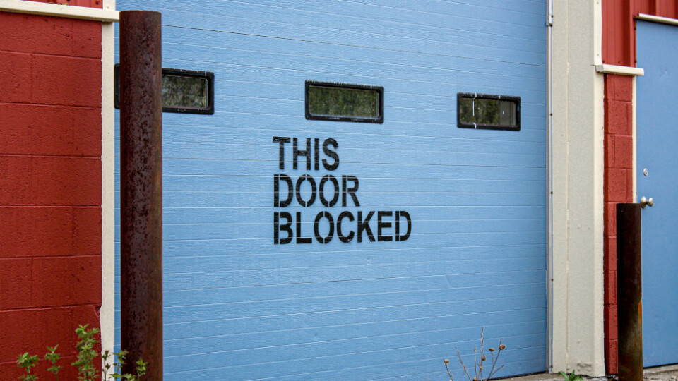 Bue garage door that has this door is blocked written across it