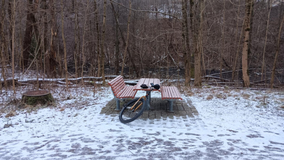 Unicycle leaning against a table with snow on the ground