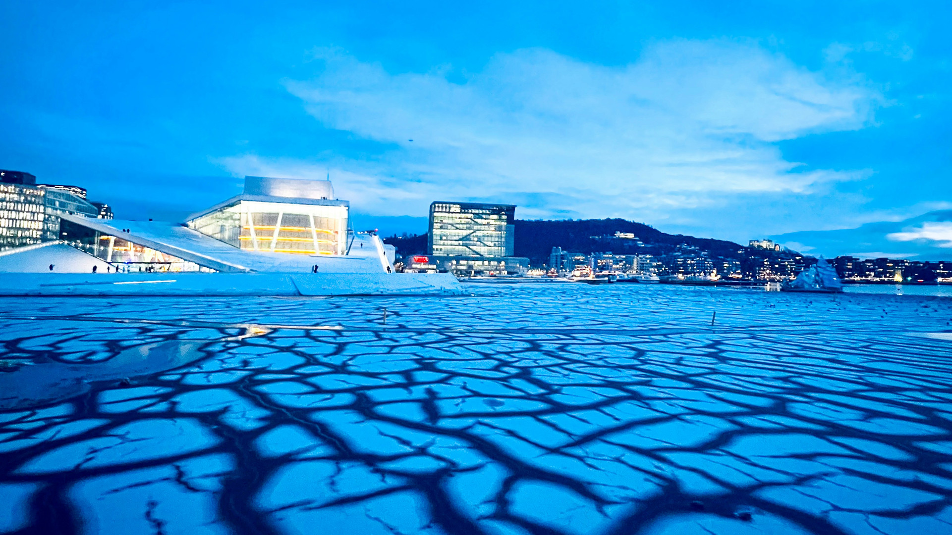 Oslo Opera house in the winter, in the evening, viewed across frozen water
