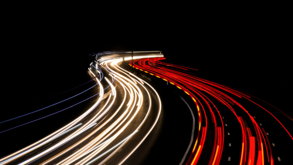 Red and white lights from long exposure of cars on a road.