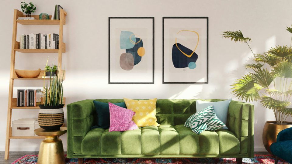 A light filled room with a green sofa a bookshelf and numerous interior design decorations.