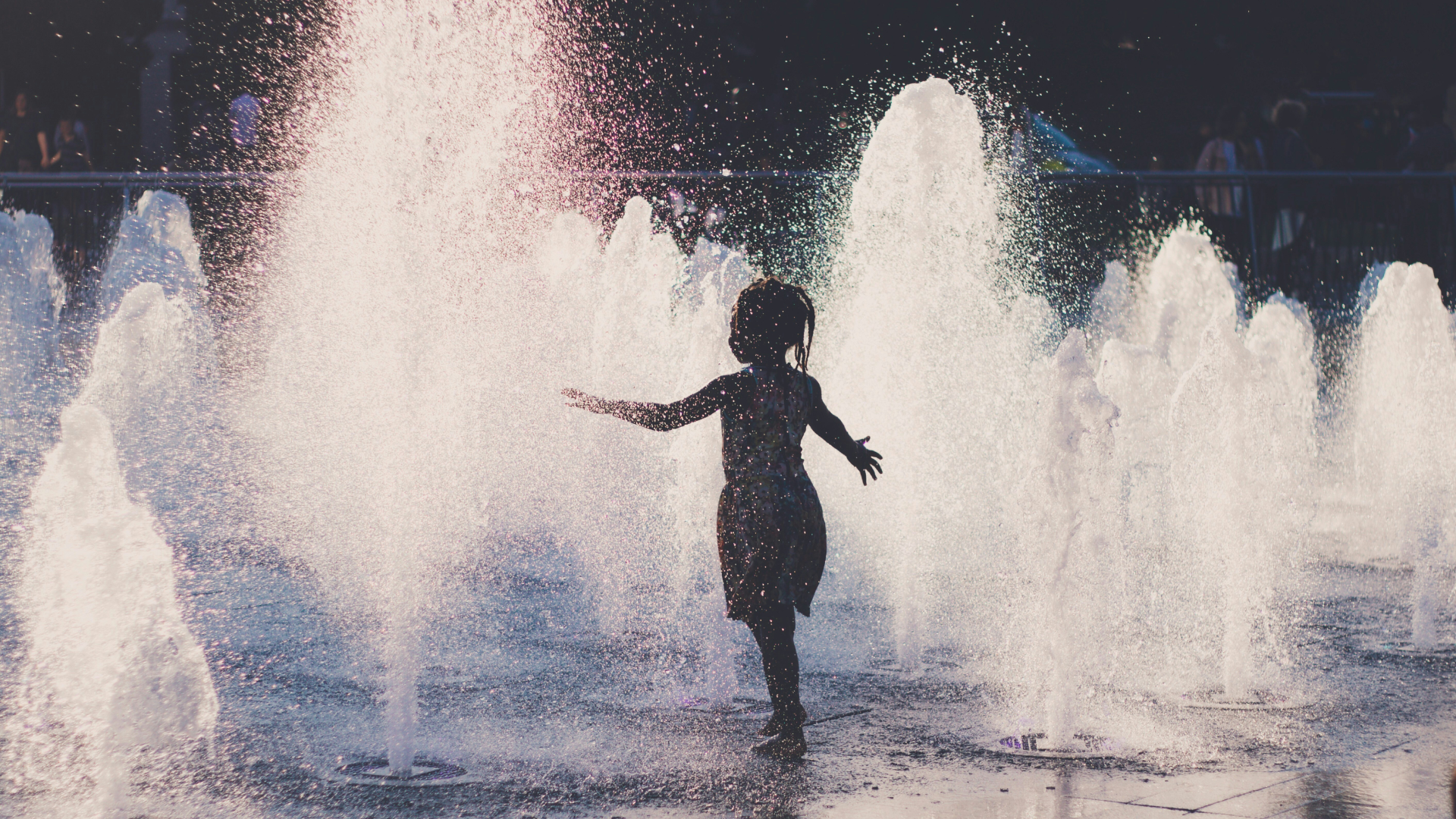 Child playing in the water fountain.