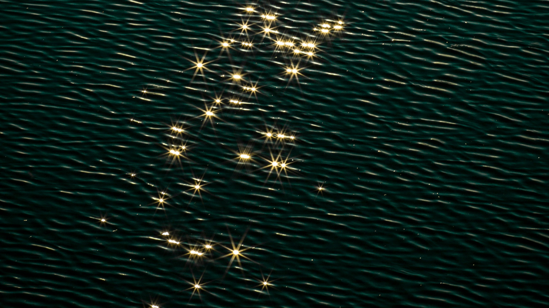 A water surface with sparkling reflections