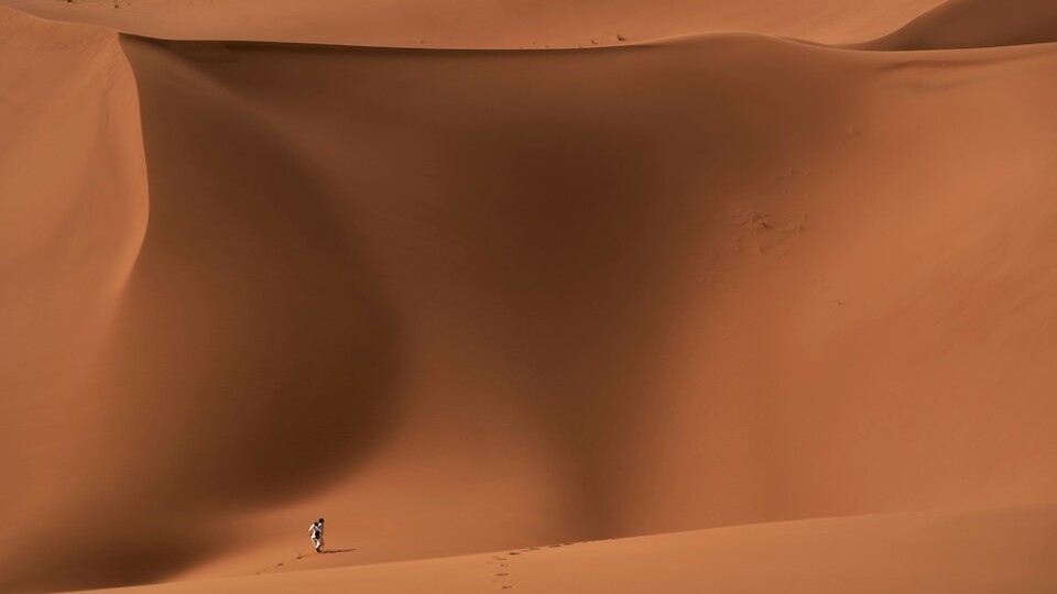 People walking on sand dunes